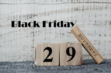 Date 29 November on wooden calendar on grey background. Black Friday