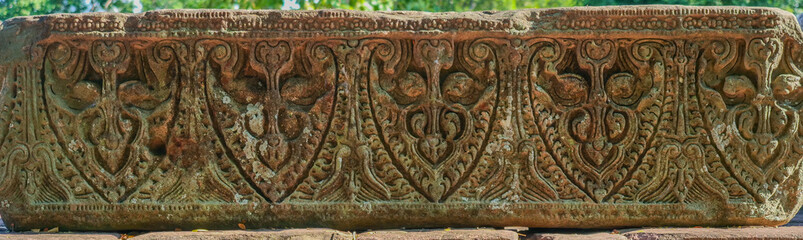 Ancient Khmer art carving on sandstone at Phimai Castle. Historical sites in Thailand.