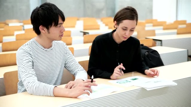 教室で勉強をする外国人の男女（国際化・留学イメージ）