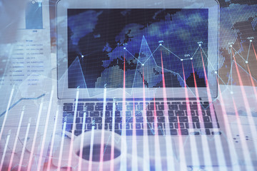 Stock market chart hologram drawn on personal computer background. Multi exposure. Concept of investment.