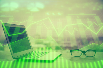 Stock market graph and table with computer background. Double exposure. Concept of financial analysis.