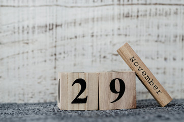 Date 29 November on wooden calendar on grey background. Black Friday