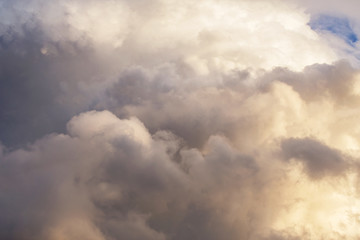 Fototapeta na wymiar Dramatic cumulus fluffy clouds in sunlight texture background