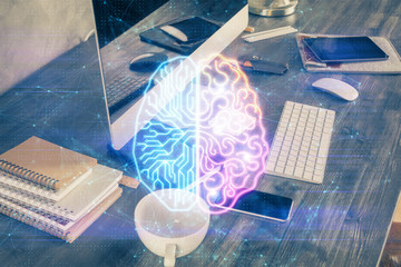 Double exposure of table with computer and brain hologram. Data innovation concept.