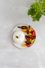 Salad with italian burrata cheese, fresh ripe tomatoes and basil