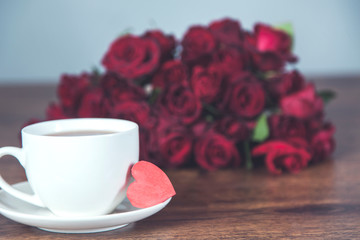 red rosses with cup of coffee and heart