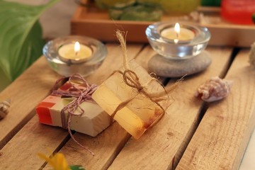 Fototapeta na wymiar Natural soap, candles, sea salt, plants, stones, shells on the table, spa procedures, relaxation, healthy lifestyle 