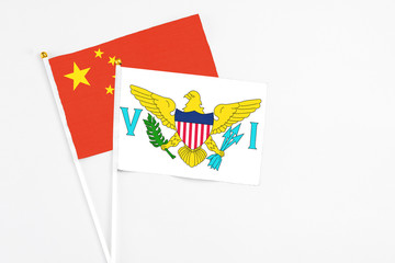 United States Virgin Islands and China stick flags on white background. High quality fabric, miniature national flag. Peaceful global concept.White floor for copy space.