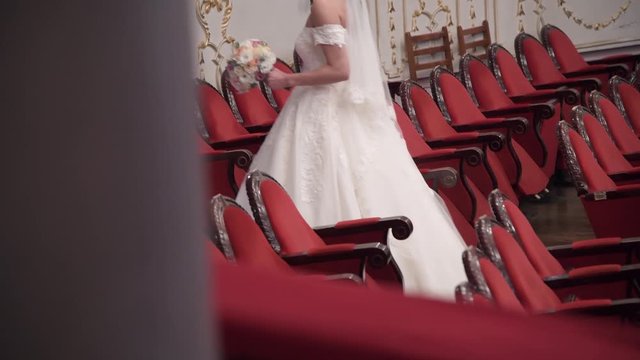 Bride walking  among the chairs