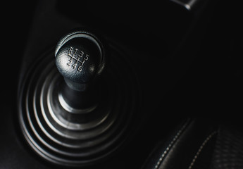 Gear stick of manual transmission of car with 6-speed and reverse position, automotive part concept.