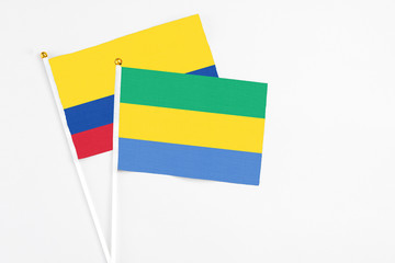Gabon and Colombia stick flags on white background. High quality fabric, miniature national flag....