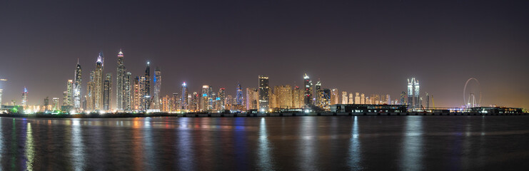 Dubai skyline panorama at night showing beautiful JBR seafront skyscrapers 