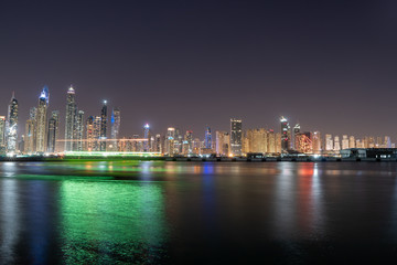 Fototapeta na wymiar Dubai skyline at night with lights and skyscrapers 