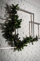 Winter home decor. Christmas tree in loft interior against brick wall.