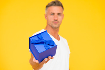 present from heart. selective focus. gift with love. happy birthday. man celebrate valentines day. goods for men. for his beloved. man gift box. macho man yellow background. man share present