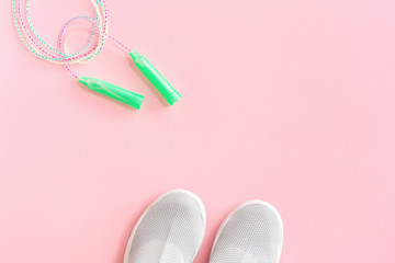 Textile sport shoes with jumping skipping rope on pink