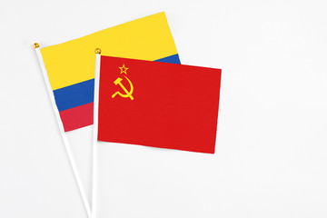 Soviet Union and Colombia stick flags on white background. High quality fabric, miniature national flag. Peaceful global concept.White floor for copy space.