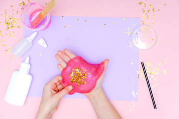 How to make slime at home. Children art project. DIY concept. Kids hands making slime toy on pink. Step by step photo instruction. Step 11 Stars