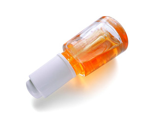 Apricot oil for nail and cuticle care in glass bottle with pipette dispenser isolated on white background. Cosmetic oil. Beauty and care concept.          
