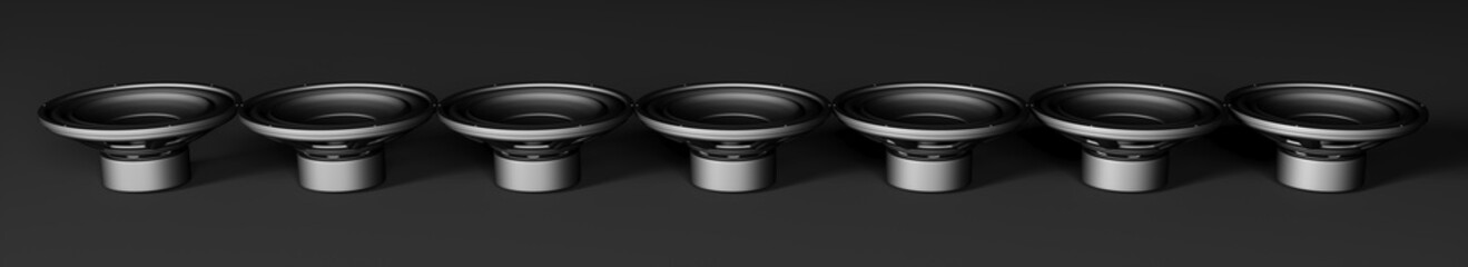 many speakers on a black background lined up in a line
