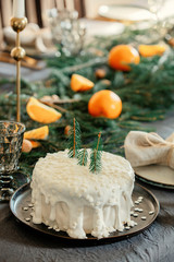 Christmas white cake on a table with pine branches