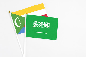 Saudi Arabia and Comoros stick flags on white background. High quality fabric, miniature national...