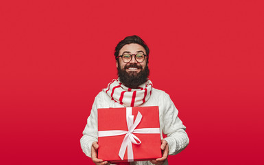 Delighted guy carrying Christmas gift