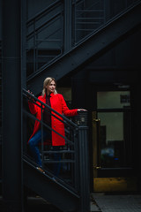 Girl in fashionable girl red warm coat  Attractive blonde city knitted sweater spring autumn collection