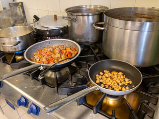 Cooking two meals - rabbit and peppers and sausage for another dish