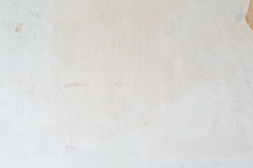 Light old wall without a ceiling. Grunge gray wall. Background texture of putty wall.