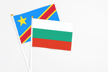 Bulgaria and Congo stick flags on white background. High quality fabric, miniature national flag. Peaceful global concept.White floor for copy space.