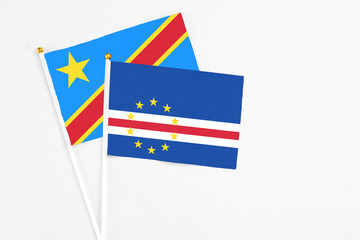 Cape Verde and Congo stick flags on white background. High quality fabric, miniature national flag. Peaceful global concept.White floor for copy space.