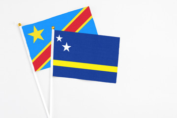 Curacao and Congo stick flags on white background. High quality fabric, miniature national flag. Peaceful global concept.White floor for copy space.
