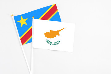 Cyprus and Congo stick flags on white background. High quality fabric, miniature national flag. Peaceful global concept.White floor for copy space.