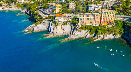 Aerial view of Camogli. Rock coast of Ligurian sea. View from above on boats and yachts. Panorama of the seaside with blue water in the summer time.