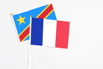 France and Congo stick flags on white background. High quality fabric, miniature national flag. Peaceful global concept.White floor for copy space.
