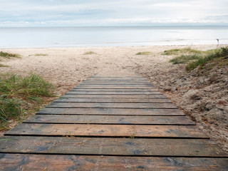 Wooden path to sandy beach, Jurmala region, Riga gulf, Latvia.