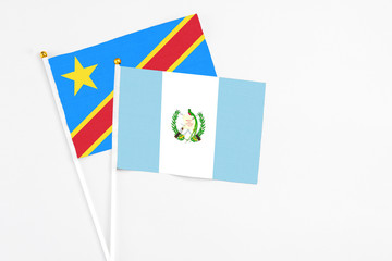 Guatemala and Congo stick flags on white background. High quality fabric, miniature national flag. Peaceful global concept.White floor for copy space.