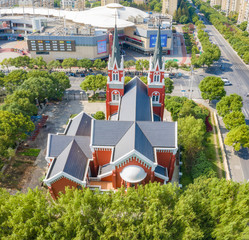 The Catholic Church in Pudong New Area, Shanghai, surrounded by green trees