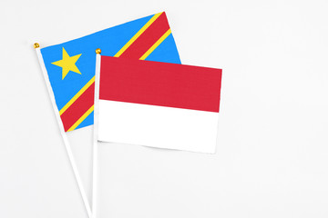 Indonesia and Congo stick flags on white background. High quality fabric, miniature national flag. Peaceful global concept.White floor for copy space.
