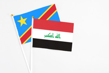 Iraq and Congo stick flags on white background. High quality fabric, miniature national flag. Peaceful global concept.White floor for copy space.