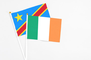 Ireland and Congo stick flags on white background. High quality fabric, miniature national flag. Peaceful global concept.White floor for copy space.