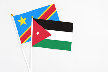 Jordan and Congo stick flags on white background. High quality fabric, miniature national flag. Peaceful global concept.White floor for copy space.