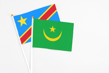 Mauritania and Congo stick flags on white background. High quality fabric, miniature national flag. Peaceful global concept.White floor for copy space.