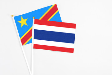 Thailand and Congo stick flags on white background. High quality fabric, miniature national flag. Peaceful global concept.White floor for copy space.