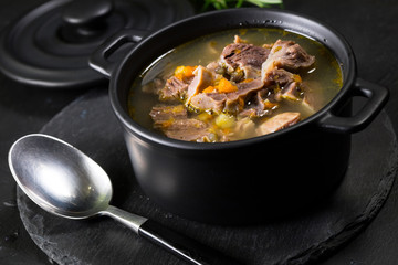 Chicken gizzards stewed with carrot in sauce.