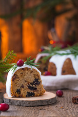 Closeup of the piece of the traditional homemade Christmas fruit cake on the wooden background