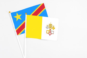 Vatican City and Congo stick flags on white background. High quality fabric, miniature national flag. Peaceful global concept.White floor for copy space.
