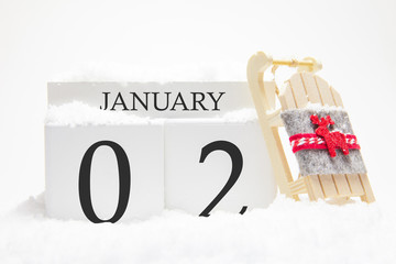 Wooden calendar for January, 2 nd day of the winter month. The symbols of winter are snow and...