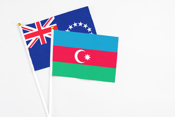 Azerbaijan and Cook Islands stick flags on white background. High quality fabric, miniature national flag. Peaceful global concept.White floor for copy space.